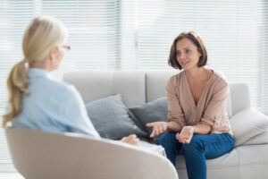 women sat in therapy room
